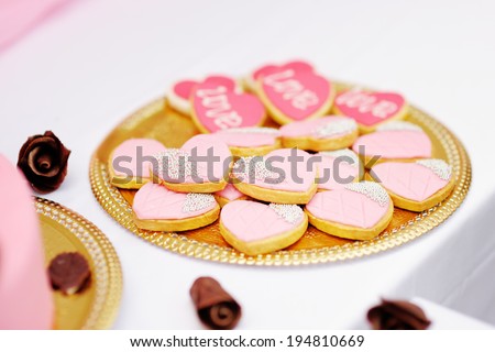 Pink cookies on golden plate 