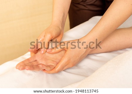 Closeup massage of female hands by physiotherapist. Carpal tunnel syndrome, arthritis, neurological disease concept. Numbness of the hand. Hand massage.