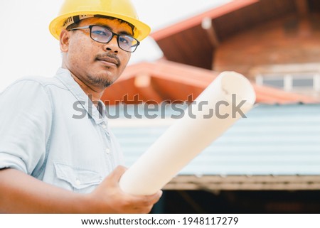 Engineers or field businessmen Planning on construction plans for a pleasant house project
