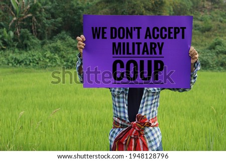 Myanmar man show sign " We don't accept military coup". Concept protest the violence from the coup in Myanmar. Royalty-Free Stock Photo #1948128796