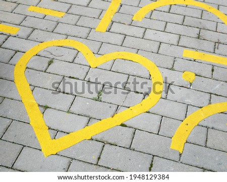 Yellow heart symbol on a parking lot