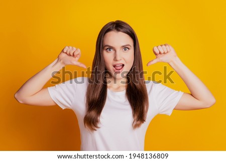 Photo of confident egocentric lady indicate thumbs herself wear white t-shirt posing on yellow background