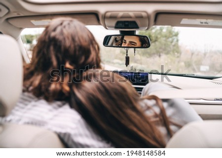 Safety and comfort in the trip. Young couple while traveling in the car, the girl leans against the guy.