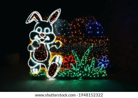 Easter decoration on the square, a rabbit and a basket with eggs