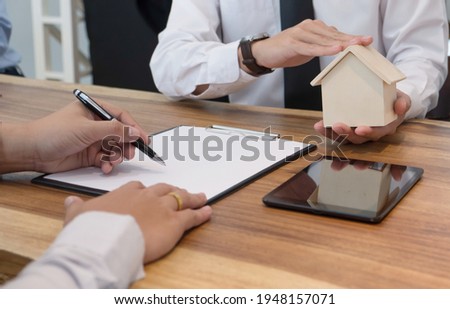 Business people signing contract making deal with real estate agent Concept for consultant and home insurance
Real estate investment Property insurance and security. Real estate agent offer