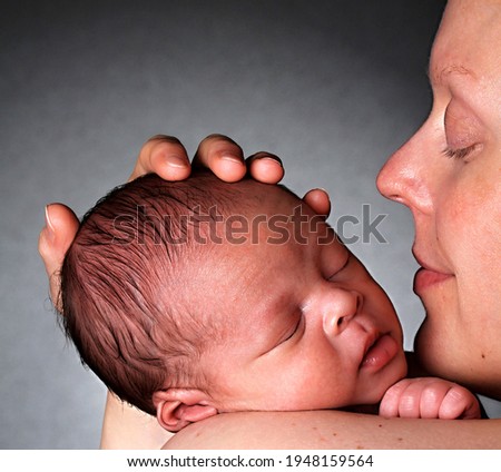 baby in mother's arms been cared for after having a good sleep in bed stock photo
