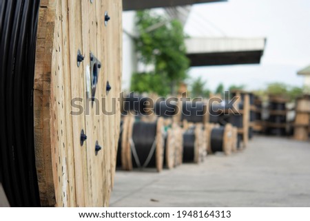 Wooden Coils Of Electric Cable Outdoor. High and low voltage cables in the storage Royalty-Free Stock Photo #1948164313