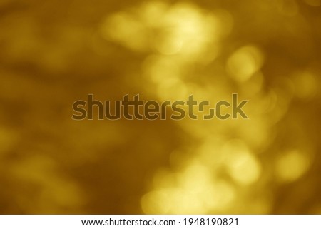 Abstract blurry bokeh with golden brown color used for background.