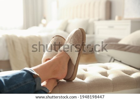 Woman wearing soft comfortable slippers at home, closeup Royalty-Free Stock Photo #1948198447