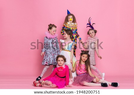 many children in costumes on a pink background. Happy birthday. Celebrating. Many kids in Halloween costumes