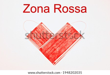 Two red Masks in a shape of a heart, with the text "Zona Rossa" translating in Red zone 