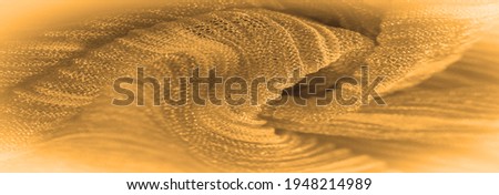  silk fabric of orange vermilion color with small corrugation, soil, context, foundation, foil, field. Texture, background, pattern,