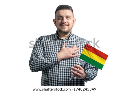 White guy holding a flag of Bolivia and holds his hand on his heart isolated on a white background With love to Bolivia.