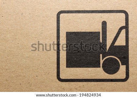 Fine image close-up of grunge black fragile symbol on cardboard