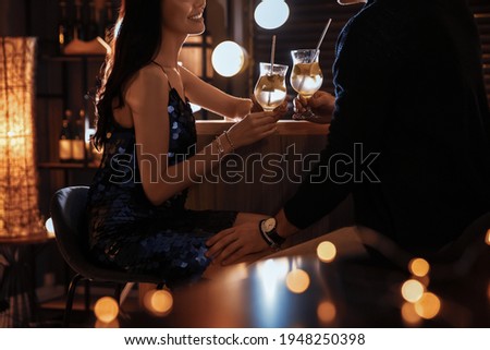 Man and woman flirting with each other in bar, closeup Royalty-Free Stock Photo #1948250398