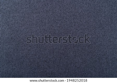 smooth surface of dense upholstery fabric of dark blue color, background, texture
