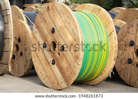Wooden Coils Of Electric Cable Outdoor. High and low voltage cables in the storage Royalty-Free Stock Photo #1948261873