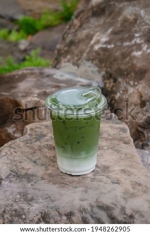 Glass of iced green tea milk drink, stock photo