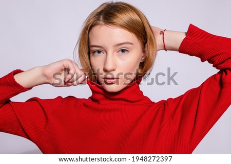 Trendy beautiful hipster girl. Photo of positive young nice woman in yellow knee-high with white background. looking at the camera