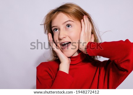 Trendy beautiful hipster girl. Photo of positive young nice woman in yellow knee-high with white background. surprised with his hand and look up