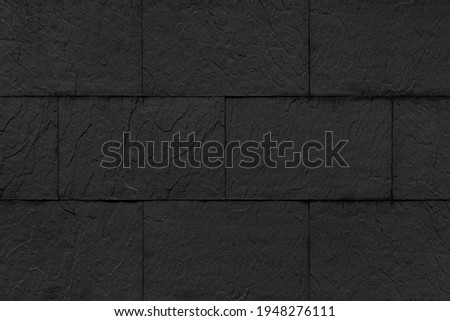 Vintage black stone brick tile wall pattern and background seamless