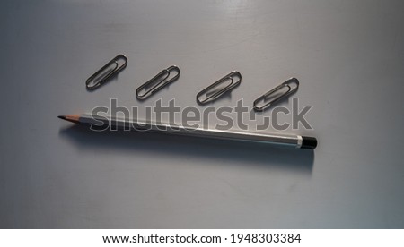 Pencil and paper clip on the table