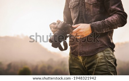 Shooting landscape photo, close up of hands photograph he is using camera