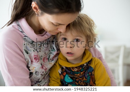 Mother, hugging sweet toddler child, blond boy at home, love and family emotions