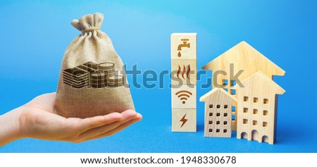 Money bag, residential buildings and blocks with communal services symbols. Utilities public service. Price, payment methods, subsidies registration. Savings, reduced environmental impact. Royalty-Free Stock Photo #1948330678