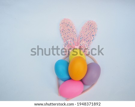 Colorful eggs and bunny ears to welcome Easter Day.