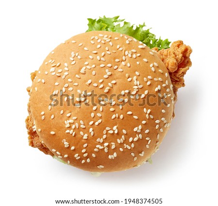 fresh tasty burger with fried chicken meat isolated on white background, top view Royalty-Free Stock Photo #1948374505