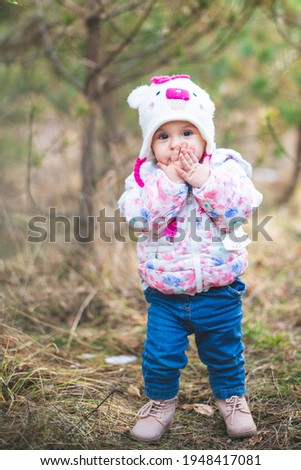 Portrait of little toddler girl having fun outdoors in cold weather at mountains