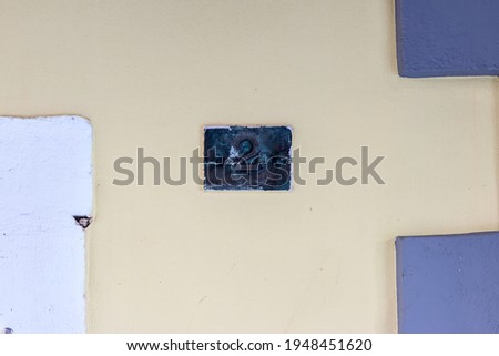 Metal plaque with number two on an old wall