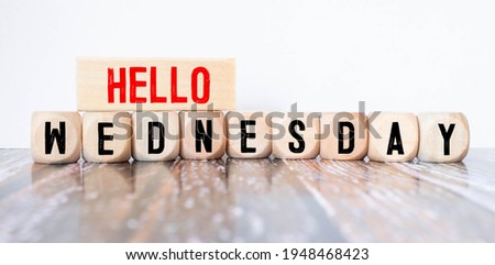 Hello wednesday word written on wood block. hello wednesday text on wooden table for your desing, concept