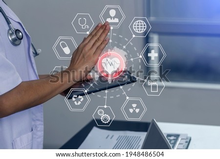 Double exposure of healthcare And Medicine concept. Doctor working with modern virtual screen interface at table office, blurred background.