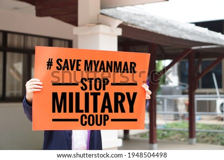 Text Save Myanmar stop military coup on paper hold by a man. Concept protest the violence from the coup in Myanmar.  Royalty-Free Stock Photo #1948504498