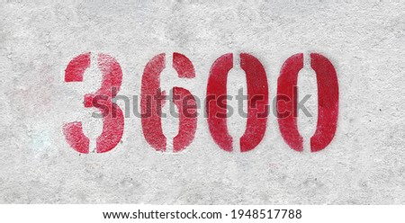 Red Number 3600 on the white wall. Spray paint.