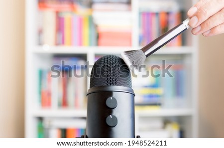 Brush touching the microphone. Making ASMR sounds with the movement of a makeup brush. Concept of recording sounds to relieve stress.
