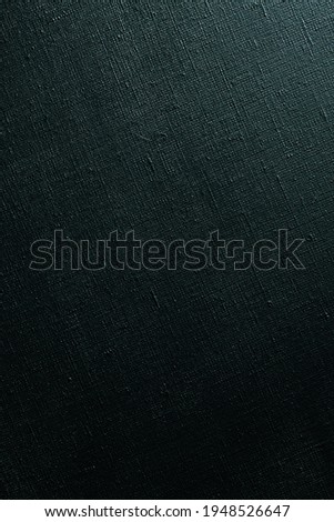 dark creative background: black primed linen canvas, uneven lighting, color toning 