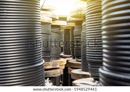 Wooden Coils Of Electric Cable Outdoor. High and low voltage cables in the storage. Royalty-Free Stock Photo #1948529461