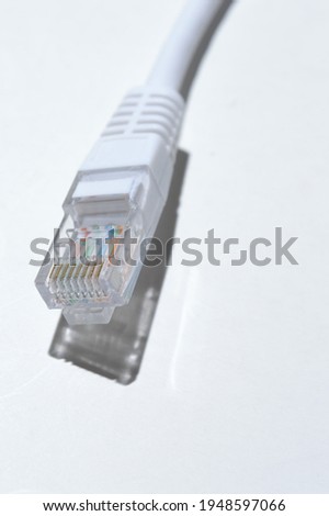 Lan wire with a tip rj 45  lies on a light background. close-up.