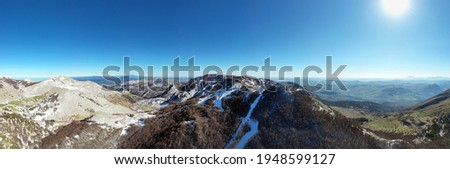 180 degree aerial drone shooting of the Madonie Mountains in winter. Skiing at Piano Battaglia during the winter. Snow in Sicily. Madonie Park. La Mufara with the ski slopes. Winter tourism in Sicily.