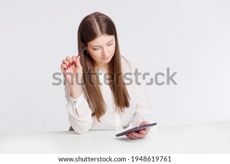portrait of a young businesswoman in a white shirt. holding a stylus pen and computer tablet