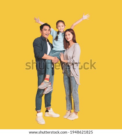 Happy Asian young family with one child standing embracing and smiling  Royalty-Free Stock Photo #1948621825