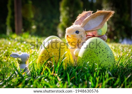 Colorful Easter eggs and a bunny in the grass of the garden