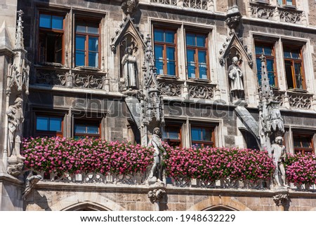 The facade of the New Town Hall is decorated with flowers. Marienplatz square. Munich, Germany