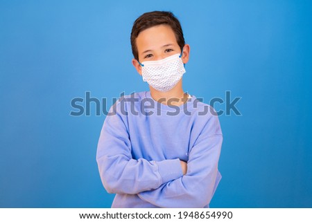 Photo of positive boy show thumb up sign wear respirator casual style outfit isolated over blue color background