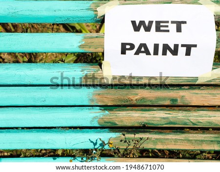 Wet paint sign on a fresh painted bench