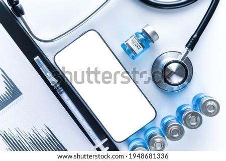 Phone mockup. Medical equipment: doctor stethoscope, hospital healthcare charts, syringe with needle and black smartphone with blank screen. Mock up generic device