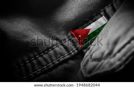 Tag on dark clothing in the form of the flag of the Jordan